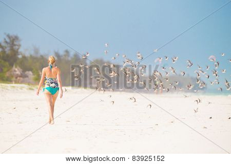Woman walking on the beach.