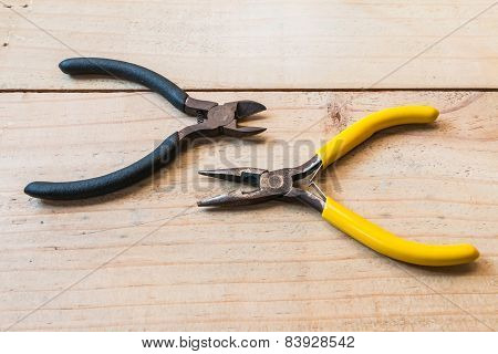 Old Wirecutters And  Pliers On The Wood