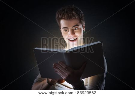 Young Man Reading An Exciting Book