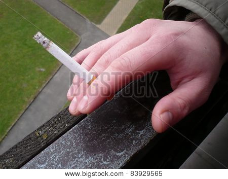 Hand with smoking cigarette