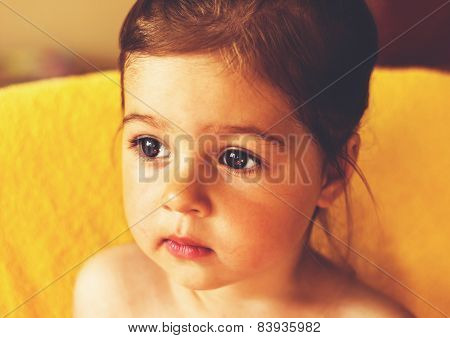 Portrait of cute sad little girl thinking.Toned