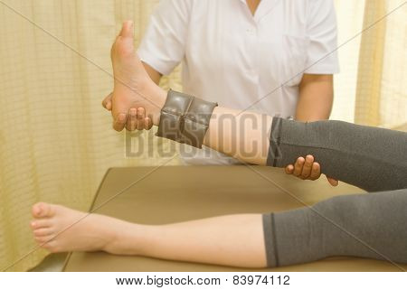 Rehab muscle training for leg with physical therapist