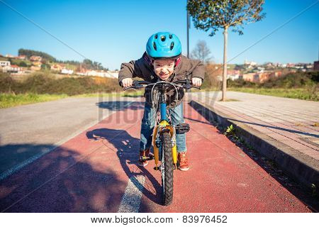Naughty boy with defiant gesture over his bike