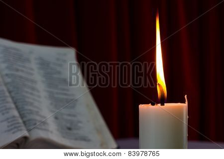 Bible Open On A Table With Candle
