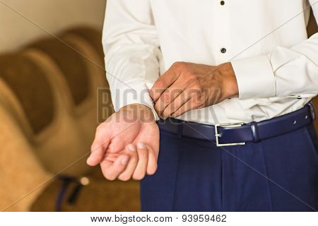 man buttons shirt
