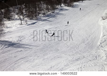 Skiers And Snowboarders On Ski Slope At Sun Winter Day