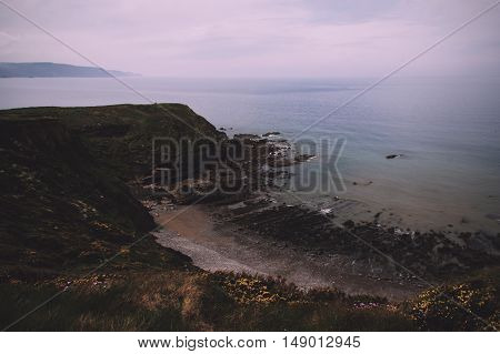 View Over The Coastline Near Widemouth Bay In Cornwall Vintage Retro Filter.