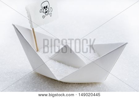 White sugar in a paper boat in a sugar sea