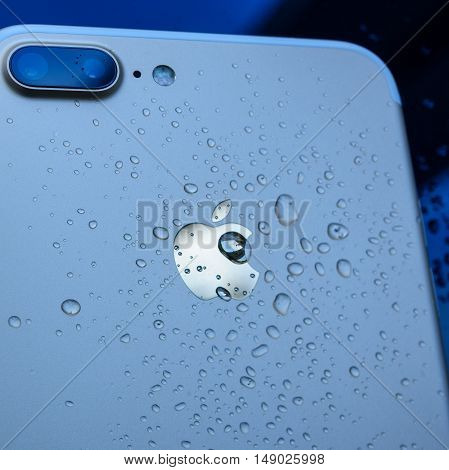 PARIS FRANCE - SEP 26 2016: New Apple iPhone 7 Plus unboxing and testing - drops on apple logo on rear of the phone. New iPhone7 is one of the best waterproof smart phone in the world