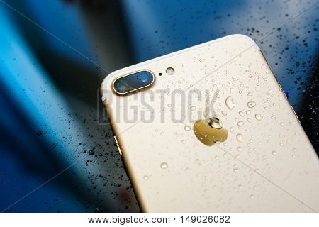 PARIS FRANCE - SEP 26 2016: New Apple iPhone 7 Plus unboxing and testing - rain drops on back of the phone. New iPhone7 is one of the best waterproof smart phone in the world