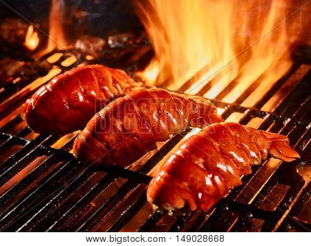 Lobster tails cooking on grill