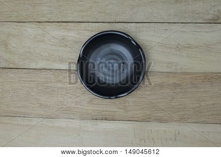 Black and red chines bowl in wooden table