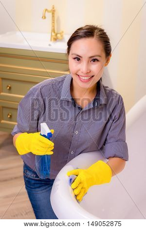 Young beautiful asian woman housekeeping in the bathroom