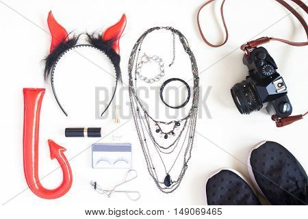 Flat lay photography with Halloween fashion accessories cosmetics essential items for woman Overhead view of Halloween accessories items top view