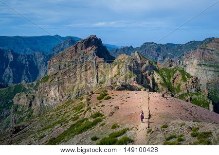 Group of tourists is walking back from Pico Ruivo hiking route number one at Madeira island.