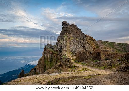 Sunset view of rocky mountain peak on the hiking path of Pico Arieiro. Madeira island, Portugal.