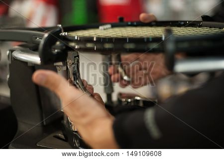 Close Up Of Tennis Stringer Hands Doing Racket Stringing