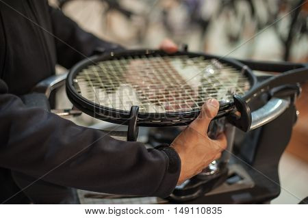 Close Up Of Tennis Stringer Hands Doing Racket Stringing