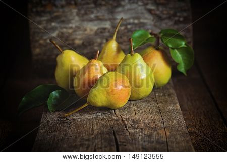 Sweet yellow pears lying on a wooden serface