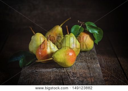 Sweet yellow pears lying on a wooden serface
