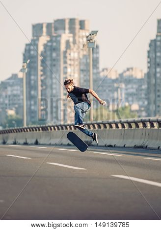 Skater Doing Tricks And Jumping On The Street Highway Bridge. Free Riding Skateboard