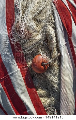 Old fishing net with buoys in the port.