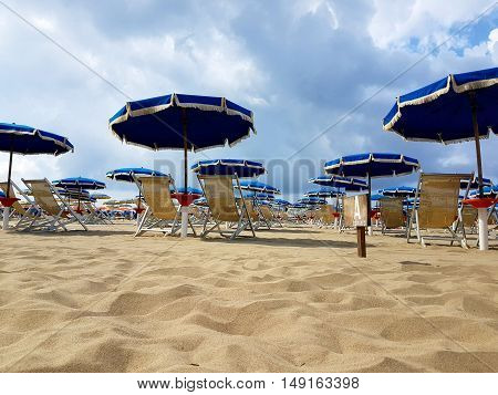 Summer backgrounds of beautiful beaches with sand and umbrellas by the sea