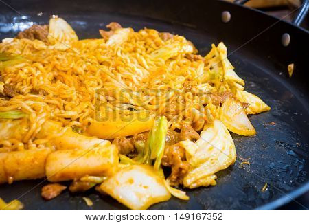 Korean style stir fried noodle with pork on hot pan