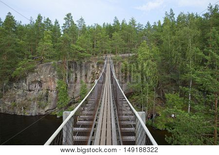 On the suspension bridge Lapinsalmi. Repovesi, Finland