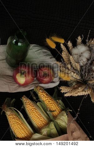 corn, lavender, apples,  bread on black background
