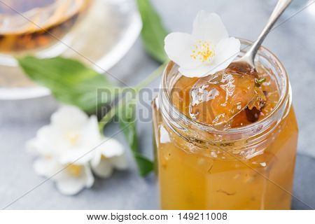 Jasmine flower confiture, jam with fresh jasmine flowers Grey stone slate background