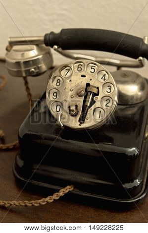 An old phone in dusty and rusty condition.