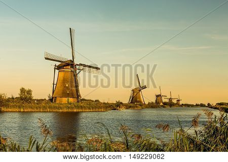 Windmills of Kinderdijk near Rotterdam in Netherlands. Colorful spring scene in the famous Kinderdijk canals with windmills, UNESCO world heritage site
