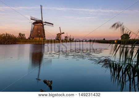 Windmills of Kinderdijk near Rotterdam in Netherlands. Colorful spring scene in the famous Kinderdijk canals with windmills, UNESCO world heritage site