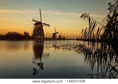 Windmills of Kinderdijk near Rotterdam in Netherlands. Colorful spring scene in the famous Kinderdijk canals with windmills, UNESCO world heritage site