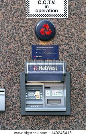 LONDON UK - February 09: NatWest ATM on urban street in London UK - February 09 2015; National Westminster Bank commonly known as NatWest is a large retail and commercial bank in the United Kingdom.