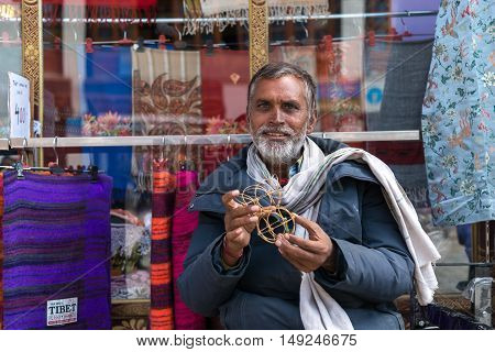 LEH LADAKH, INDIA - JULY 19, 2016 : Unidentified male selling products on street market in Leh city, Ladakh, Inidia on Jul 19, 2016.