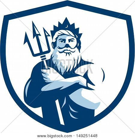 Illustration of triton mythological god arms crossed holding trident viewed from front set inside shield crest on isolated background done in retro style.