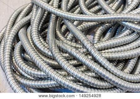 Flexible metal pipe on a background .