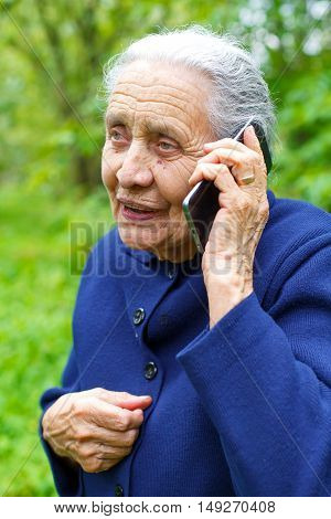 Picture of a happy old woman talking on the phone