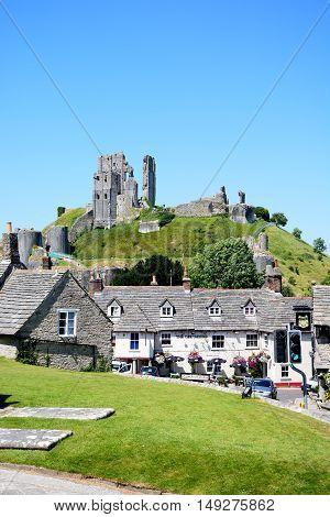 CORFE, UNITED KINGDOM - JULY 19, 2016 - View of Corfe castle seen above The Greyhound Pub Corfe Dorset England UK Western Europe, July 19, 2016.
