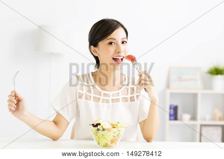 beautiful young asian woman eating healthy food
