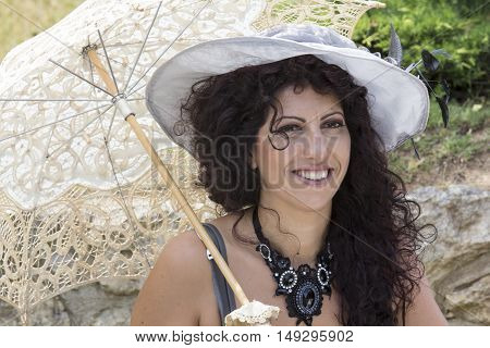 CAGLIARI, ITALY - June 1, 2014: Sunday at La Grande Jatte public gardens - Sardinia - portrait of a beautiful woman in Victorian costumes
