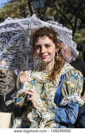 CAGLIARI, ITALY - May 29, 2016: Sunday at La Grande Jatte VIII Ed. At the Public Gardens - Sardinia - portrait of a beautiful girl in Victorian costumes