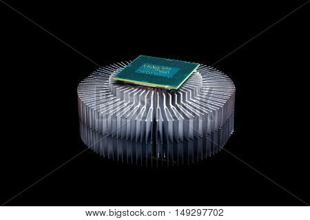 Computer processor chip CPU with aluminum cooler on black reflective background