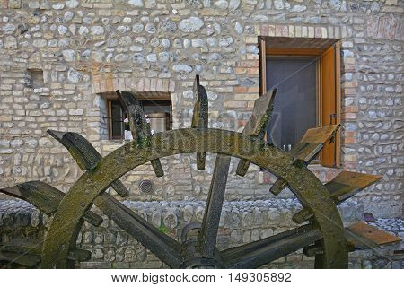 An old historic wooden water wheel in the north east Italian town of Valvasone in Friuli Venezia Giulia