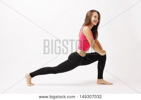 Fitness woman stretching legs doing pilates leg stretches