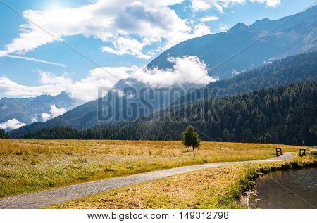 Great view of the azure pond Champfer in alpine valley. Popular tourist attraction. Picturesque and gorgeous scene. Location Swiss alps, Silvaplana village, district of Maloja, Europe. Beauty world.