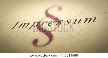 Word Impressum printed on a paper texture with blur effect and silcrow symbol