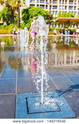 NICE, FRANCE - AUGUST 28, 2016: People among fountains at Promenade du Paillon - 12 hectares, 1.2km long new green pedestrian walkway area in the heart of Nice, France
